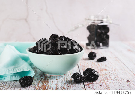 Sweet dried prunes in bowl and jar on table Sweet dried prunes in bowl and jar on table 119498755
