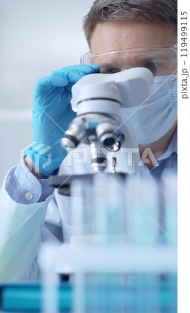 Man scientist with protective glasses, mask and gloves is using Man scientist with protective glasses, mask and gloves is using 119499115