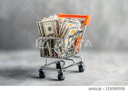 Shopping cart full of us dollar banknotes over grey background 119500389