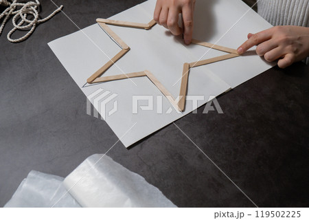 Christmas star ice cream sticks handmade Storytelling creating craft Christmas holiday decoration. Tactile hand-on activity. Master class progress of creative me-made gifts. Seasonal domestic life 119502225