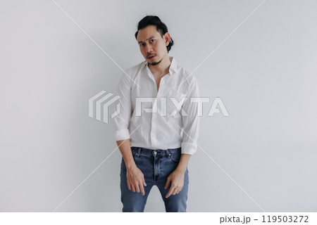 Sad face long hair man bun in white shirt and jean stand on white. Sad face long hair man bun in white shirt and jean stand on white. 119503272