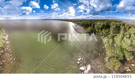 Big lake with green shores in bright sun light and city on horizon, aerial landscape. Recreation concept. Aerial view 119504655
