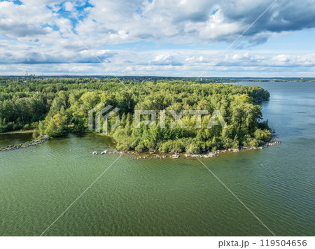 Aerial view of lake or river green shore with forest. Summer season. Aerial view of lake or river green shore with forest. Summer season. 119504656