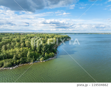 Aerial view of lake or river green shore with forest. Summer season. 119504662