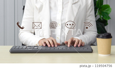 Contact us or Customer support hotline people connect. Businesswoman typing on computer keyboard showing symbol of contact icons (email address, live chat, internet wifi). Contact us or Customer support hotline people connect. Businesswoman typing on computer keyboard showing symbol of contact icons (email address, live chat, internet wifi). 119504756
