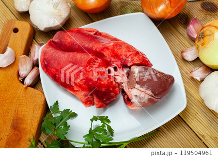 Raw lamb lungs and heart served with greens, nobody 119504961
