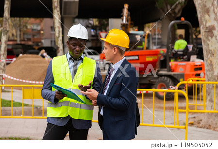 Foreman and engineer having conversation about road paving works Foreman and engineer having conversation about road paving works 119505052