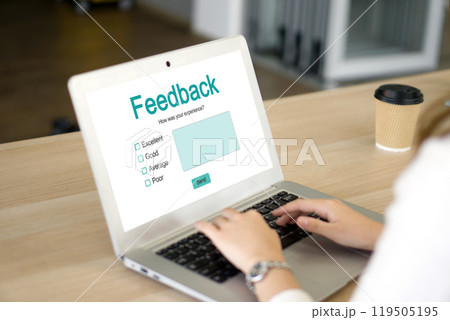 A lady is busy typing on her laptop computer which shows a feedback form on its screen. A lady is busy typing on her laptop computer which shows a feedback form on its screen. 119505195