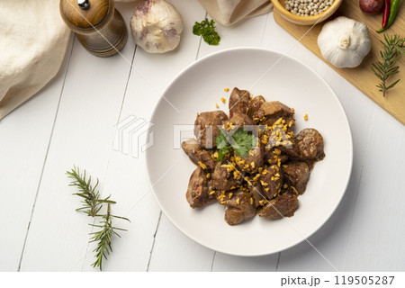 Fried chicken Liver with Garlic,Stir fry sliced liver with peppercorn and garlic in white plate.Top view 119505287