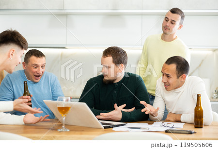 Group of men comforting distressed friend at computer at home 119505606