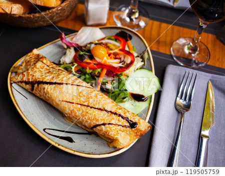 Filled pancake with balsamic and fresh vegetable salad 119505759