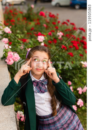 Young girl posing surrounded by pink and red flowers. Young girl posing surrounded by pink and red flowers. 119505863