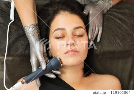 Woman receiving phonophoresis ultrasound facial treatment Woman receiving phonophoresis ultrasound facial treatment 119505864