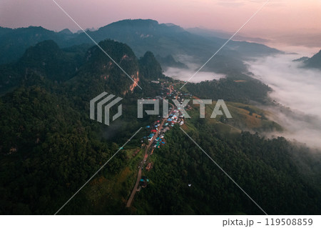 Aerial view of Morning fog and mountains with a rural village and sunrise from above 119508859