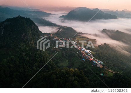 Aerial view of Morning fog and mountains with a rural village and sunrise from above 119508861