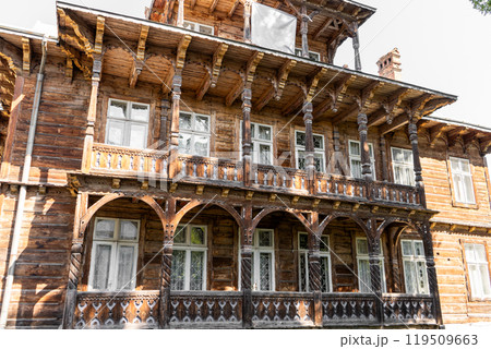 Wooden house. Windows and balcony of an old building. 119509663