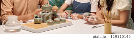 Family Drinking Tea At The Table 119510149