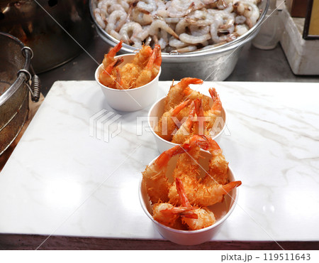 Traditional korean fast food - crispy fried shrimp tempura, Myeong dong district, Seoul, Republic of Korea. Deep fried shrimp in the street market in the area Myeongdong, Seoul, South Korea Traditional korean fast food - crispy fried shrimp tempura, Myeong dong district, Seoul, Republic of Korea. Deep fried shrimp in the street market in the area Myeongdong, Seoul, South Korea 119511643