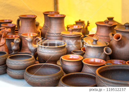 Traditional Russian Pottery. Clay Cups, Jugs, Plates, and Bowls on a Craftsmans Stall. Traditional Russian Pottery. Clay Cups, Jugs, Plates, and Bowls on a Craftsmans Stall. 119512237