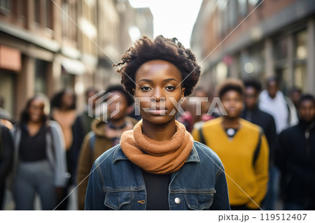 African-American female activist stands with black protesters during a rally. 119512407
