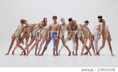 Contemporary ballet group in synchronized pose against light background. Contemporary ballet group in synchronized pose against light background. 119513326