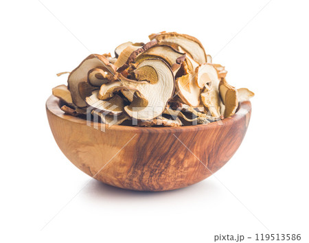 Dried porcini mushrooms. Sliced boletus in bowl isolated on white background. 119513586