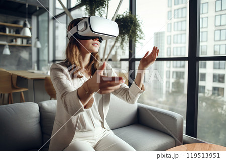 Amazed woman, wearing VR glasses, enjoys the immersive virtual reality experience on her sofa at home. 119513951