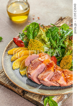Roast duck breast with orange and greens. copy space, top view Roast duck breast with orange and greens. copy space, top view 119515640