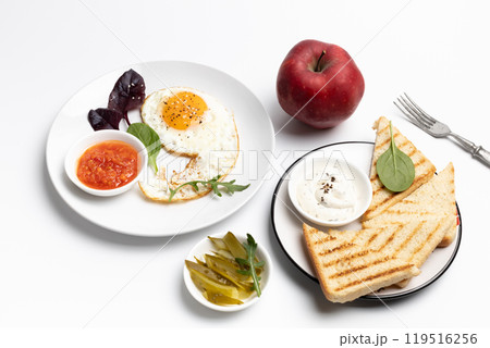 Fried egg on the plate, pickled cucumbers and bread, Fried egg on the plate, pickled cucumbers and bread, 119516256