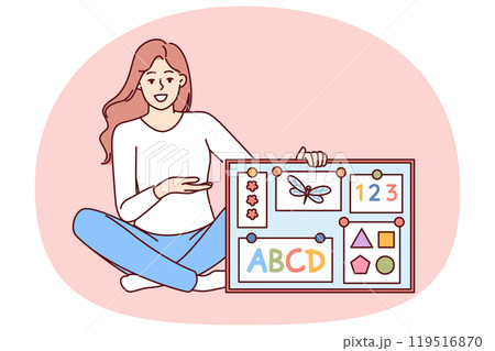 Woman english teacher in elementary school with magnetic board with multi-colored alphabet 119516870
