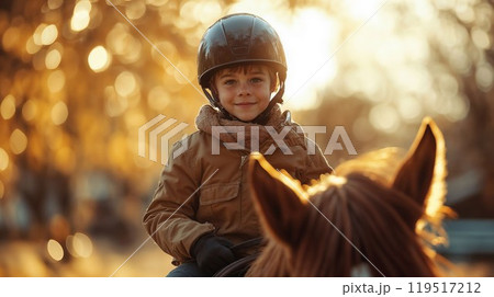 A young boy who is wearing a safety helmet is riding a horse 119517212