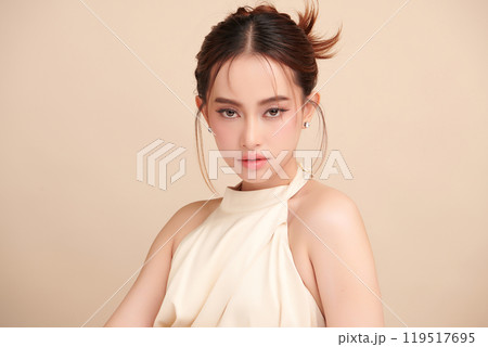 Beautiful young asian woman with clean fresh skin on beige background, Face care, Facial treatment, Cosmetology, beauty and spa, Asian women portrait. Beautiful young asian woman with clean fresh skin on beige background, Face care, Facial treatment, Cosmetology, beauty and spa, Asian women portrait. 119517695