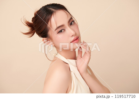 Beautiful young asian woman with clean fresh skin on beige background, Face care, Facial treatment, Cosmetology, beauty and spa, Asian women portrait. 119517710