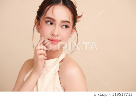 Beautiful young asian woman with clean fresh skin on beige background, Face care, Facial treatment, Cosmetology, beauty and spa, Asian women portrait. Beautiful young asian woman with clean fresh skin on beige background, Face care, Facial treatment, Cosmetology, beauty and spa, Asian women portrait. 119517712