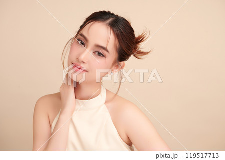 Beautiful young asian woman with clean fresh skin on beige background, Face care, Facial treatment, Cosmetology, beauty and spa, Asian women portrait. 119517713