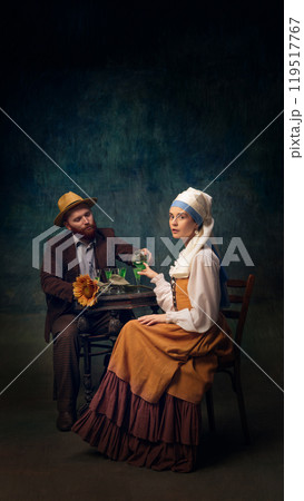 Cinematic portrait of man and woman sitting, drinking alcohol drinks. Van Gogh and girl with white pearl at date. 119517767