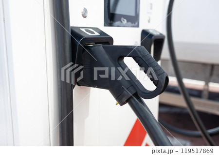 e-car charging station, e-car charge point or electric vehicle supply equipment (EVSE) with information sign electric car public charging point station and charge cable, charging plug parking spaces e-car charging station, e-car charge point or electric vehicle supply equipment (EVSE) with information sign electric car public charging point station and charge cable, charging plug parking spaces 119517869