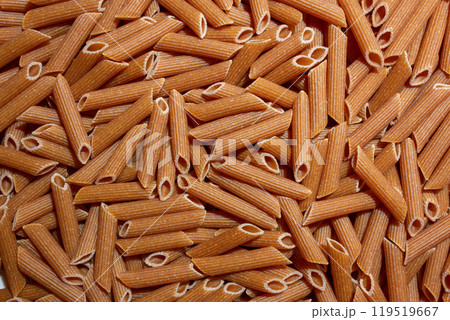 Uncooked Whole Grain Penne Rigate Pasta Background 119519667