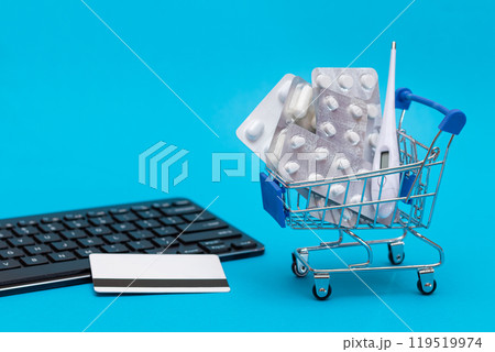 Ordering Medicines. Pills and Capsules in a Shopping Cart on Blue Background Ordering Medicines. Pills and Capsules in a Shopping Cart on Blue Background 119519974