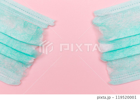 Green Torn Medical Face Mask on the Pink Background Green Torn Medical Face Mask on the Pink Background 119520001