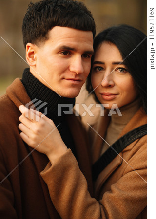Young couple in love walking in the park on a autumn day. Enjoying time together. 119521169