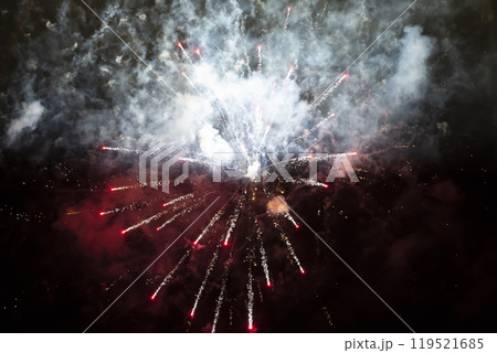 Red spots of fireworks in smoke on a black background. Festive background. Red spots of fireworks in smoke on a black background. Festive background. 119521685