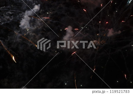 Smoke and spots of fireworks on a black background. Smoke and spots of fireworks on a black background. 119521783