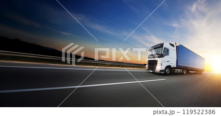 European truck driving on the asphalt road in rural landscape at sunset 119522386