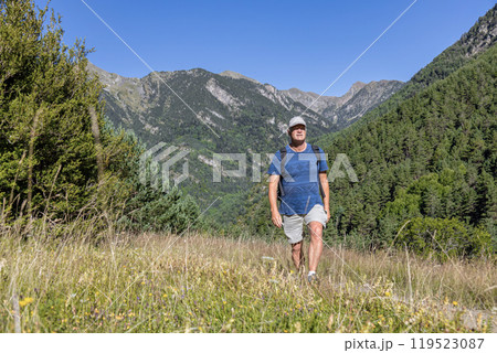 Young pretty tourist man with backpack walking in the mountain 119523087