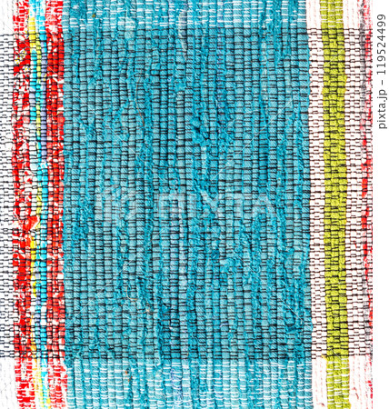 Old handmade homespun doormat from strips of cloth 119524499