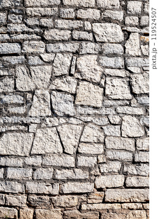 Ancient weathered rough stone wall as creative background 119524507