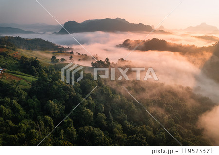 Aerial View of Morning fog and mountains as the sun rises from above Aerial View of Morning fog and mountains as the sun rises from above 119525371