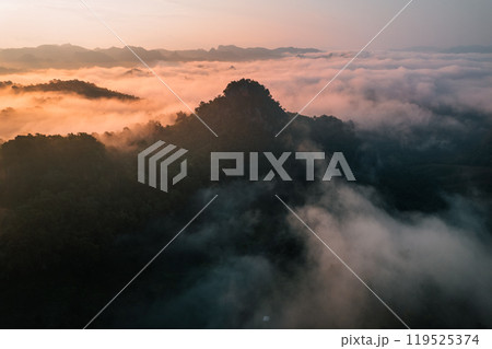 Aerial View of Morning fog and mountains as the sun rises from above Aerial View of Morning fog and mountains as the sun rises from above 119525374