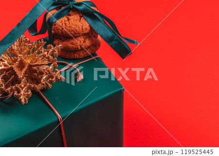 Gift box with decoration and baked goods on a red background 119525445
